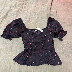 Francesca's Black Puff-Sleeve Peplum Top with Pink & Red Bow Print